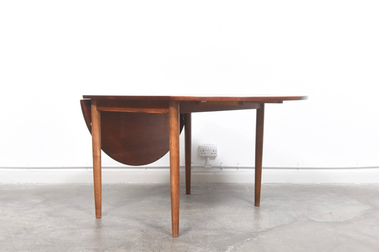 Narrow teak dining table with drop leaves