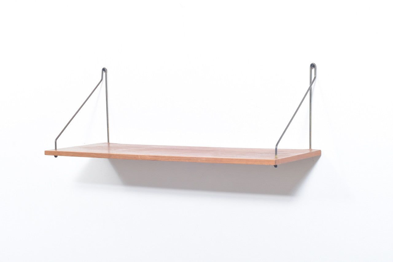 Floating shelf in teak with brass supports