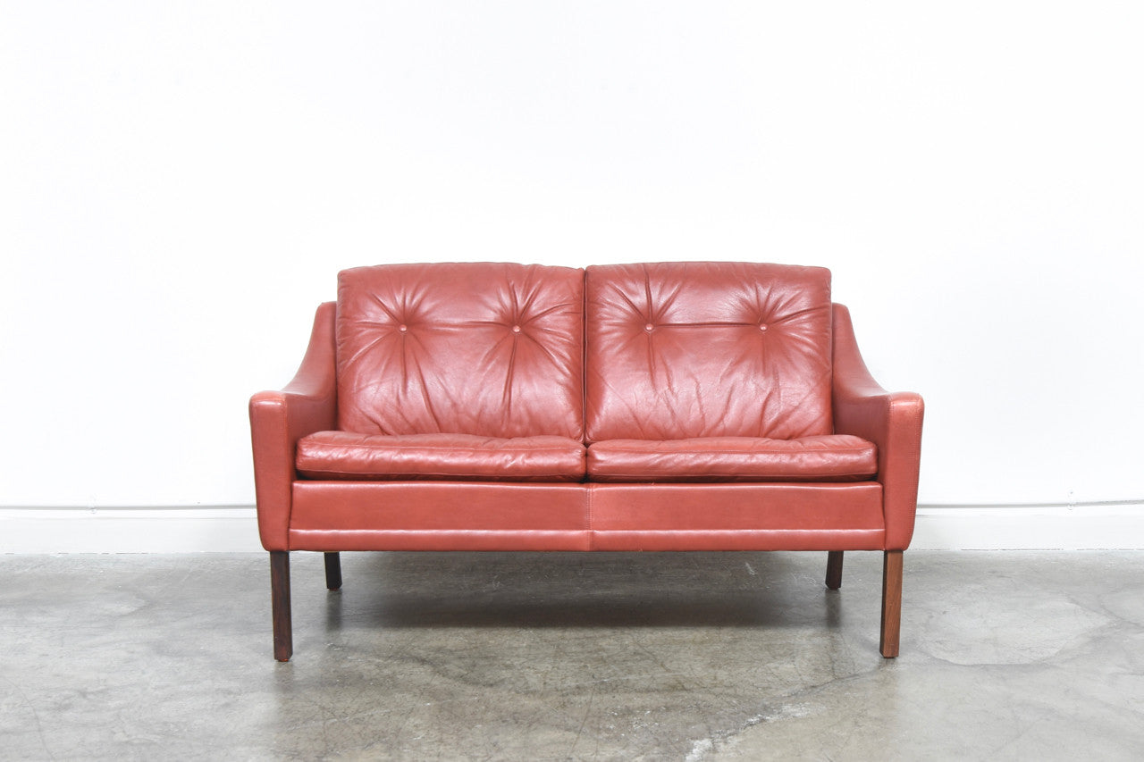 Red leather two seat sofa