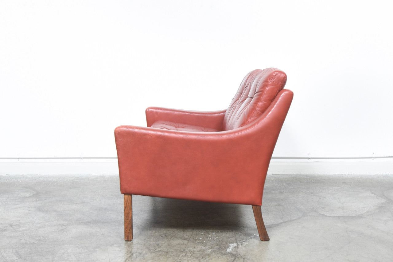 Red leather two seat sofa