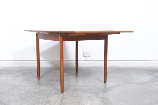 Extending square dining table in teak