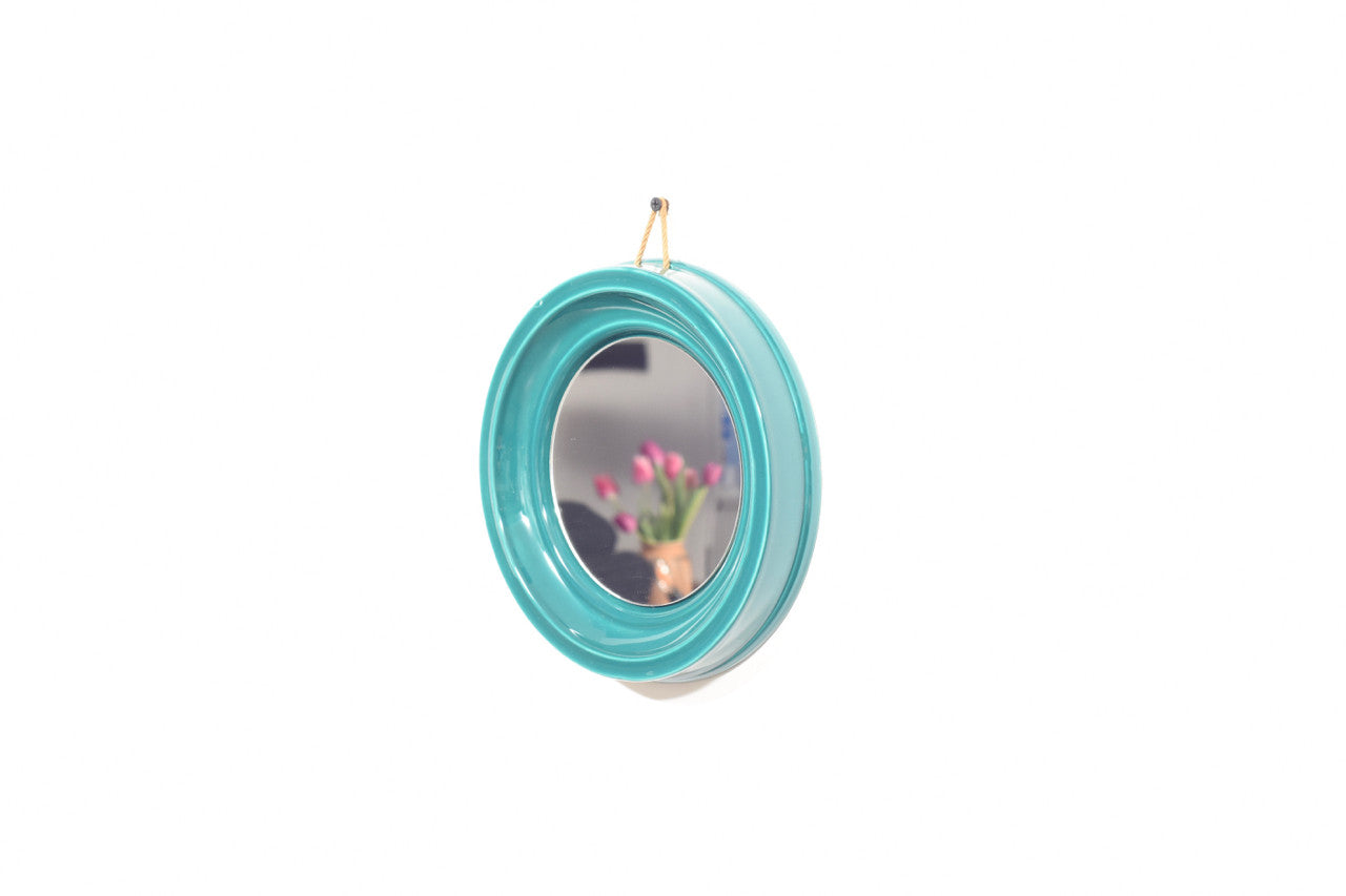 Round mirror with ceramic surround