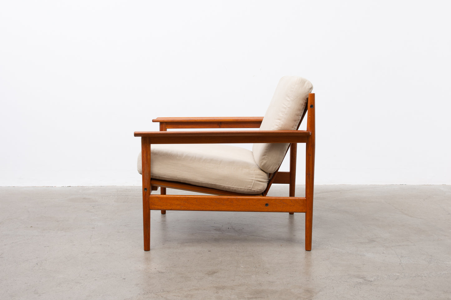 1960s teak lounger with linen cushions