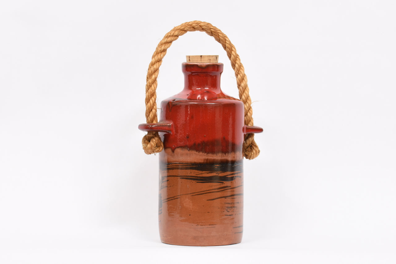 Stoneware jug with cork lid and rope handle