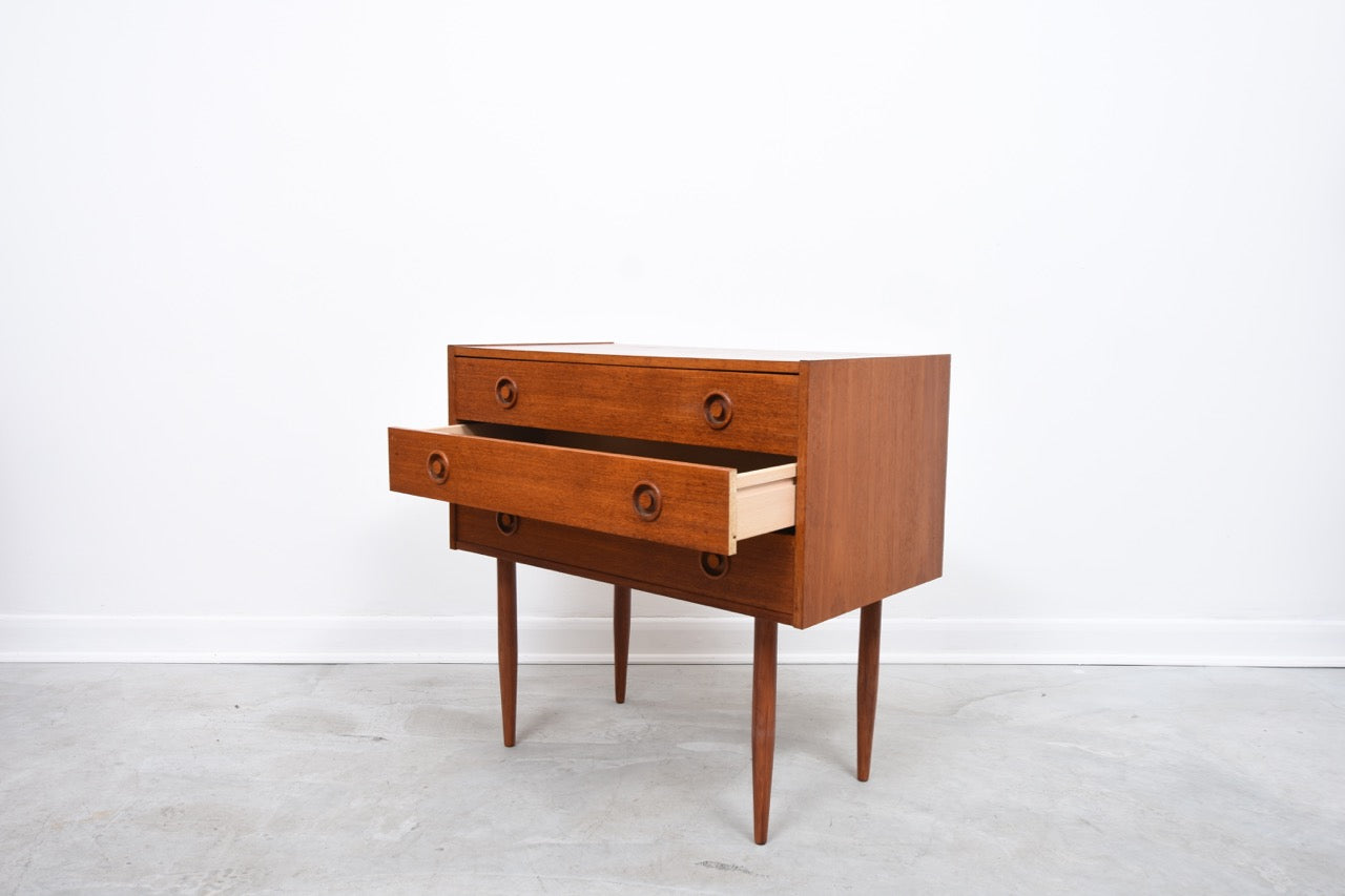 Low teak chest of three drawers