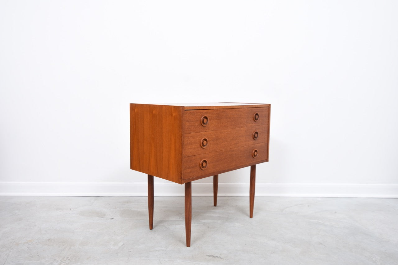 Low teak chest of three drawers