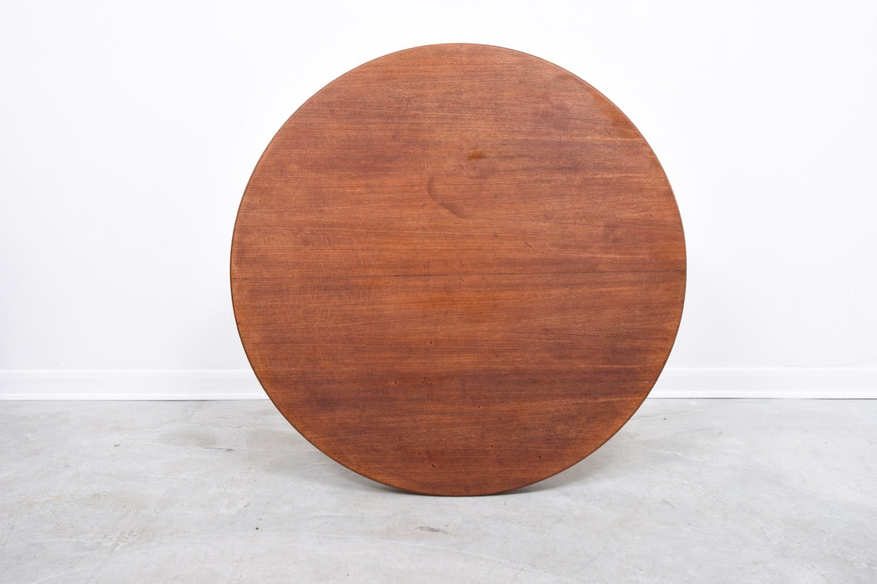 Extending round teak dining table