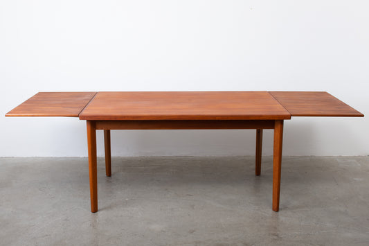 Extending teak dining table by Henning Kjærnulf