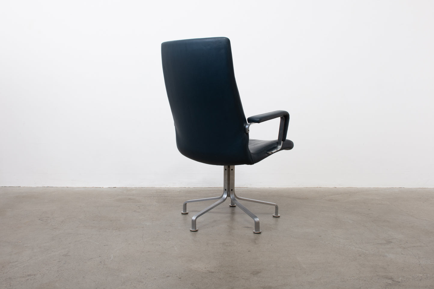 Four available: 1980s leather + steel armchairs by Arne Vodder