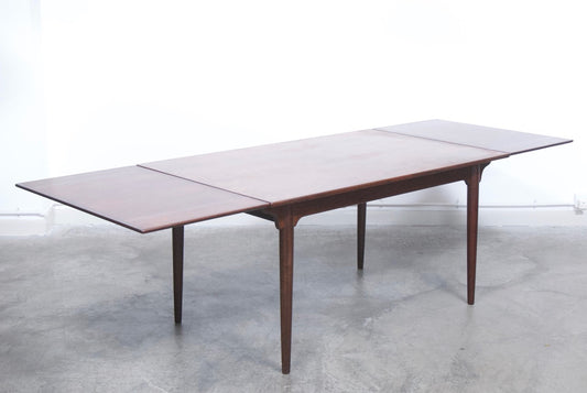 Extending rosewood dining table by Omann Junior