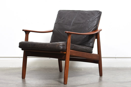 Teak lounge chair with leather cushions