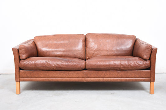 Maroon leather two and a half seat sofa
