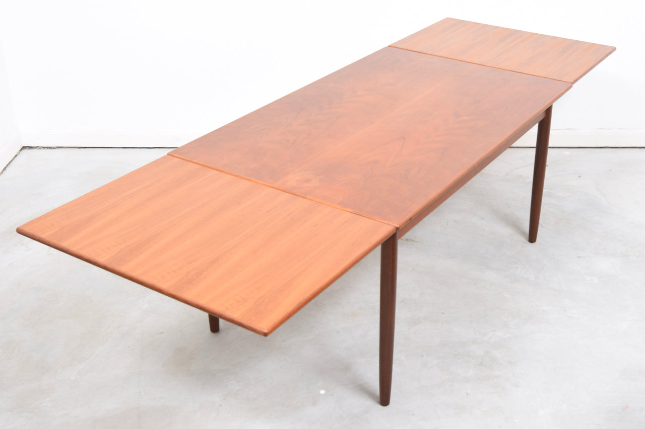 Extending rectangular dining table in teak