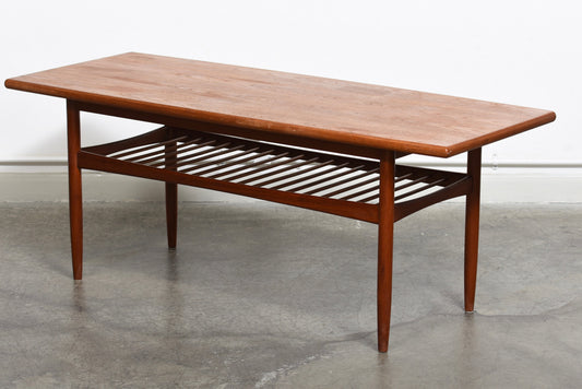 Teak coffee table with slatted magazine shelf