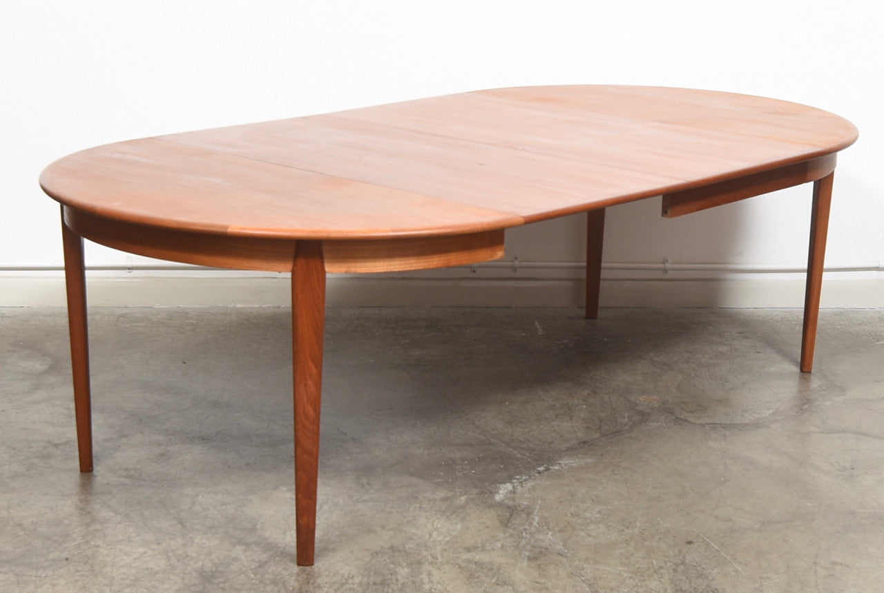 Extending teak dining table