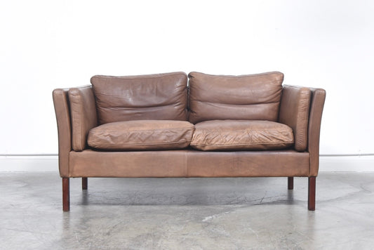 Two seat leather sofa with feather cushions