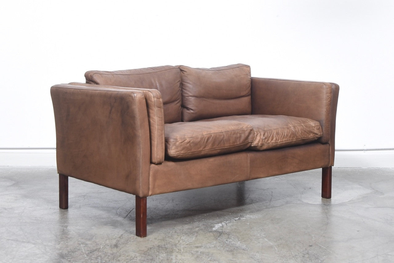 Two seat leather sofa with feather cushions