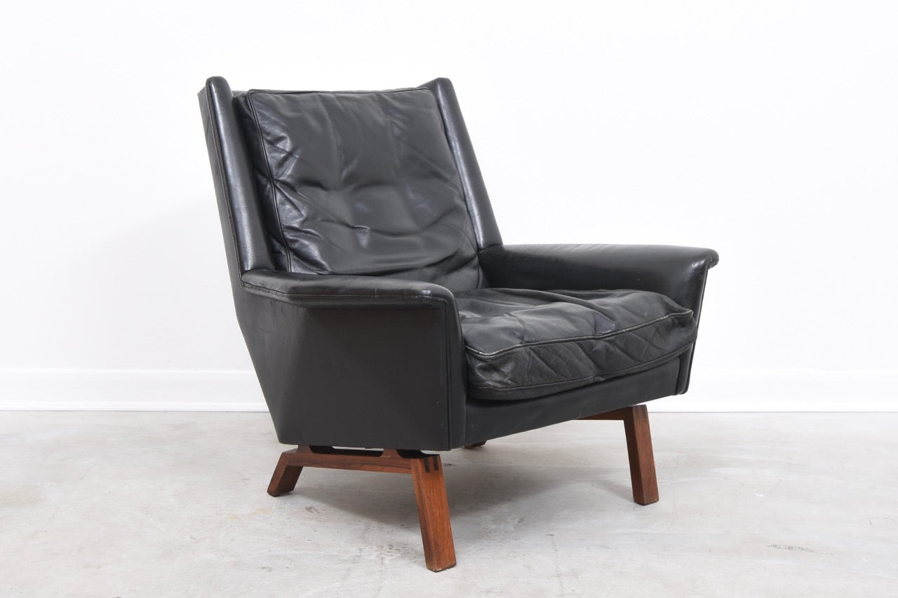 High back leather lounger on rosewood base