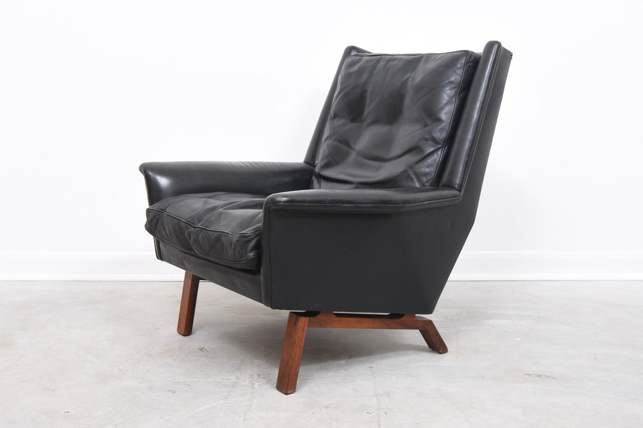 High back leather lounger on rosewood base