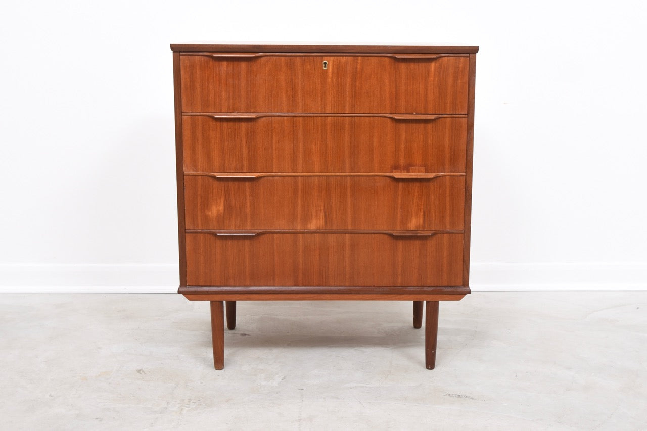Low chest of four deep drawers in teak