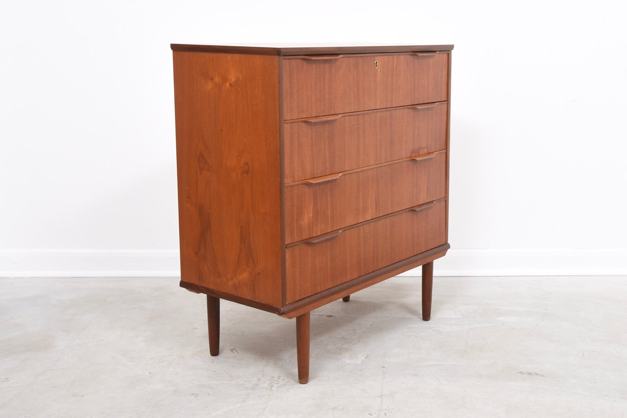 Low chest of four deep drawers in teak