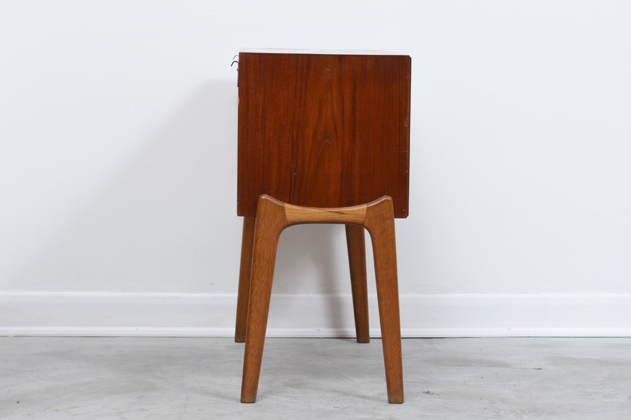 Low teak cabinet on oak base