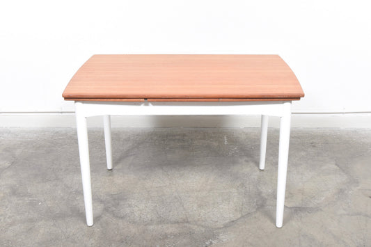 Extending teak dining table with lacquered base