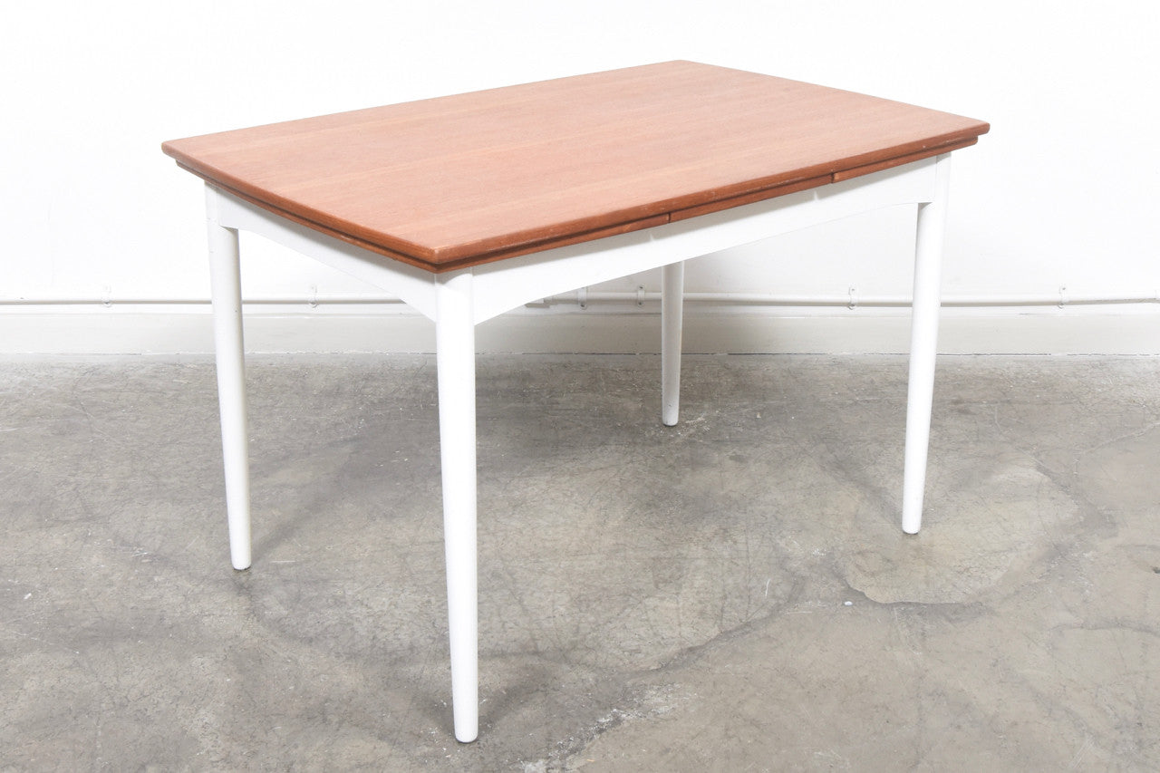 Extending teak dining table with lacquered base