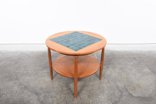 Round coffee table with tiled inlay