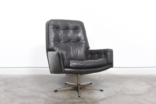 Dark brown leather lounge chair on swivel base
