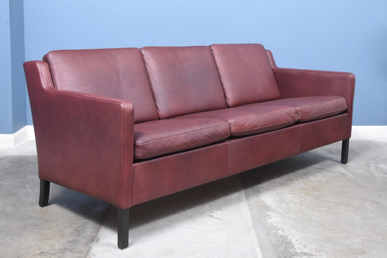 Three seat sofa in maroon leather