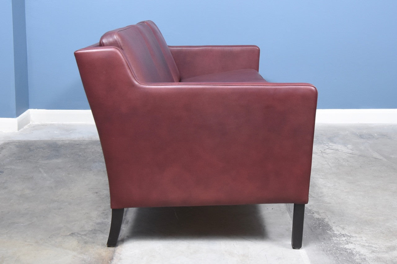 Three seat sofa in maroon leather