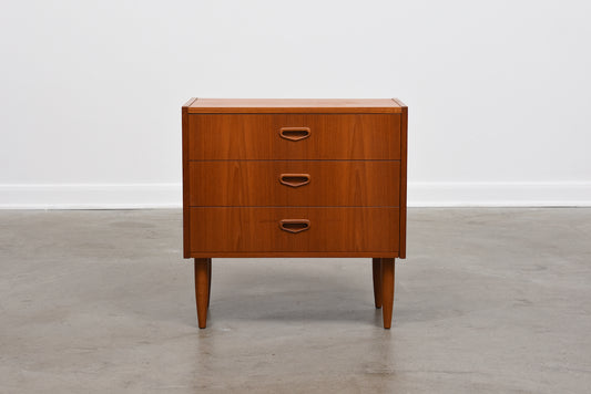 Low chest of three teak drawers