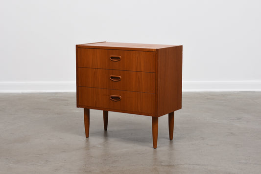 Low chest of three teak drawers