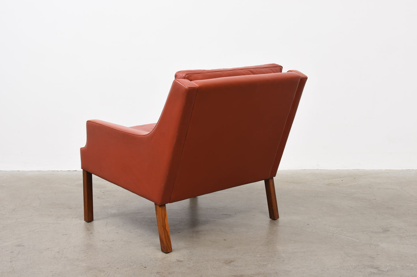 Two available: Leather + rosewood loungers by Rud Thygesen