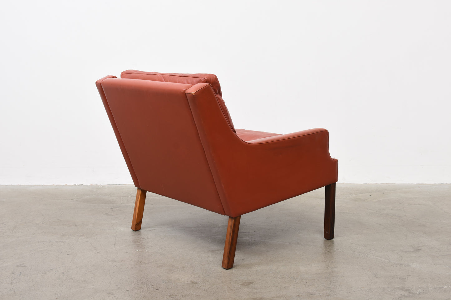 Two available: Leather + rosewood loungers by Rud Thygesen