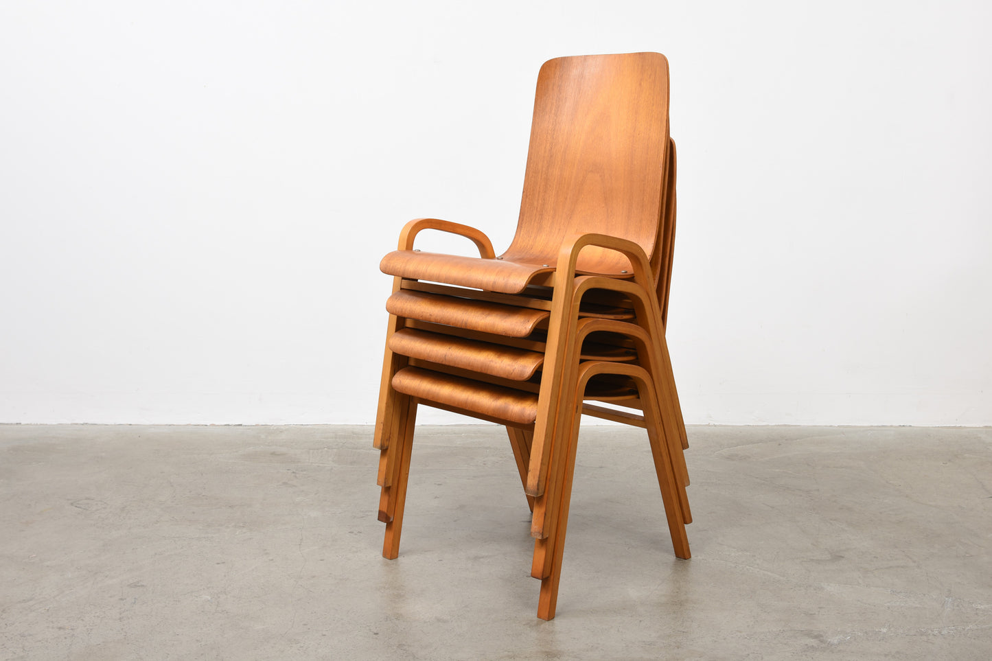 Set of four teak + beech stacking chairs