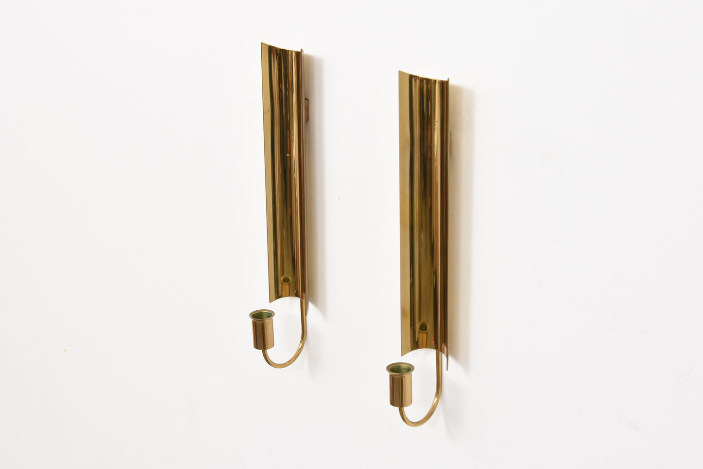Two available: 'Reflex' brass candle holders by Pierre Forsell