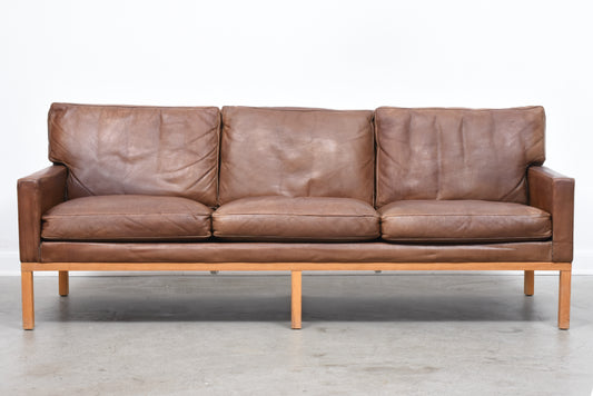 Vintage three seat leather sofa on oak base