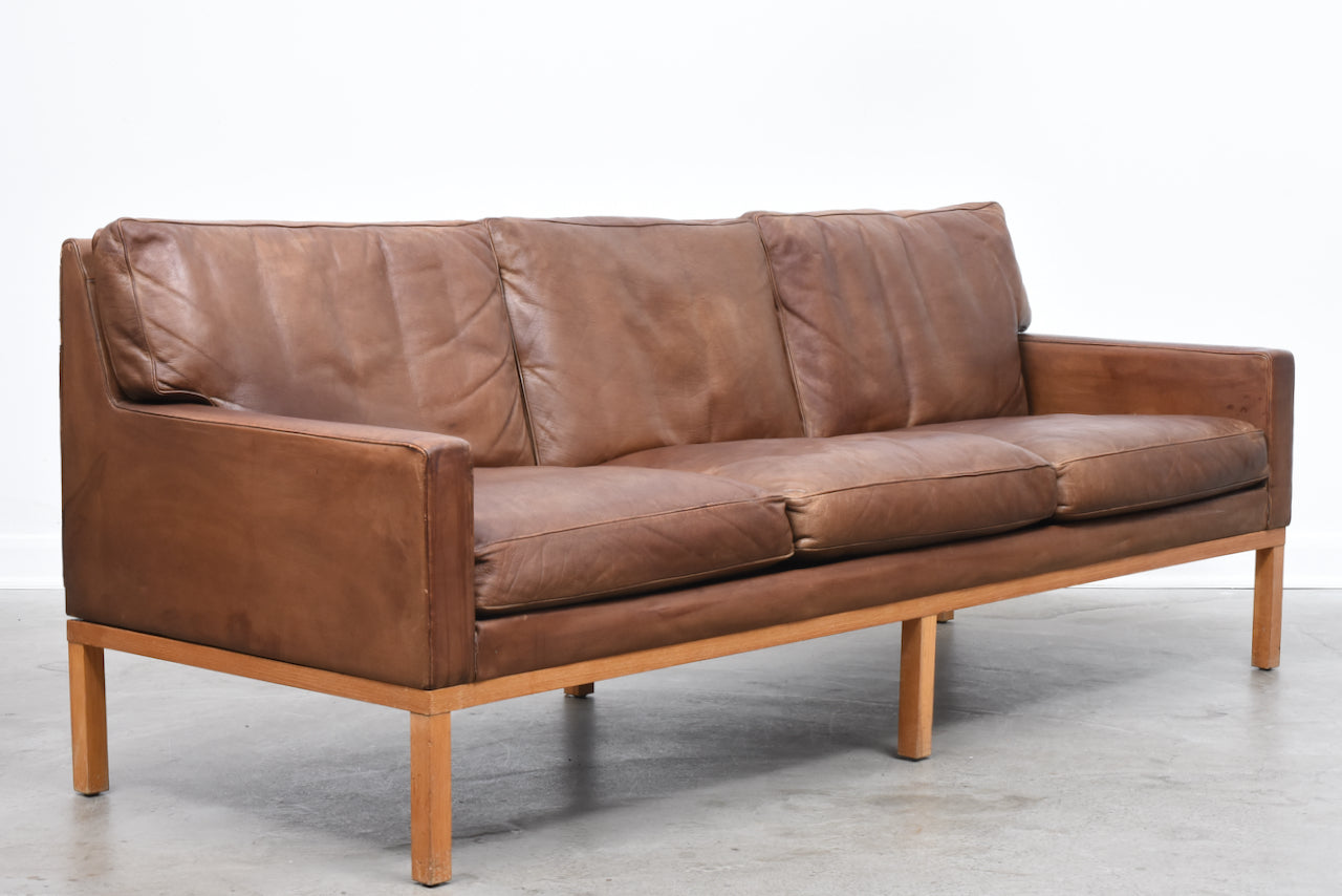 Vintage three seat leather sofa on oak base