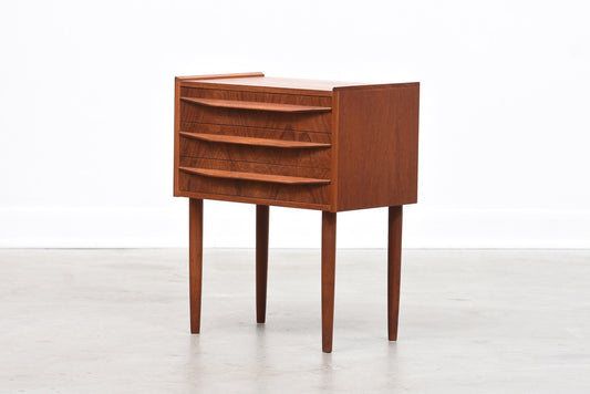 Low teak chest of three drawers