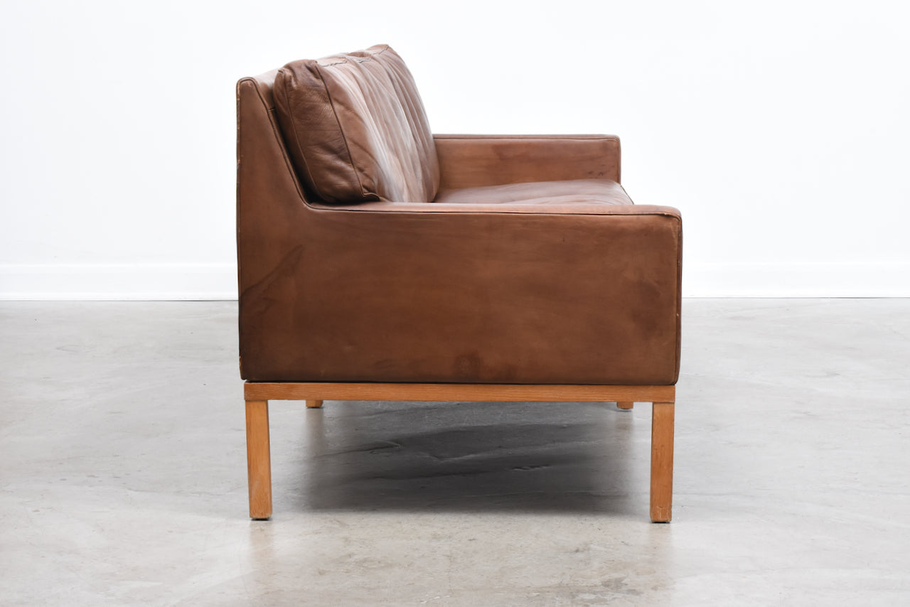 Vintage three seat leather sofa on oak base