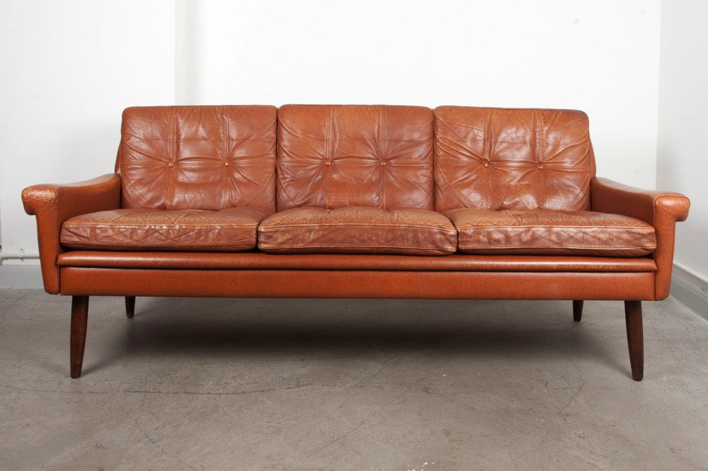 Three seat tan leather sofa by Skipper