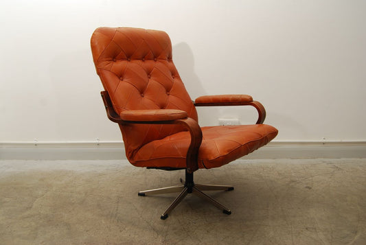 Cognac leather lounge chair on swivel base